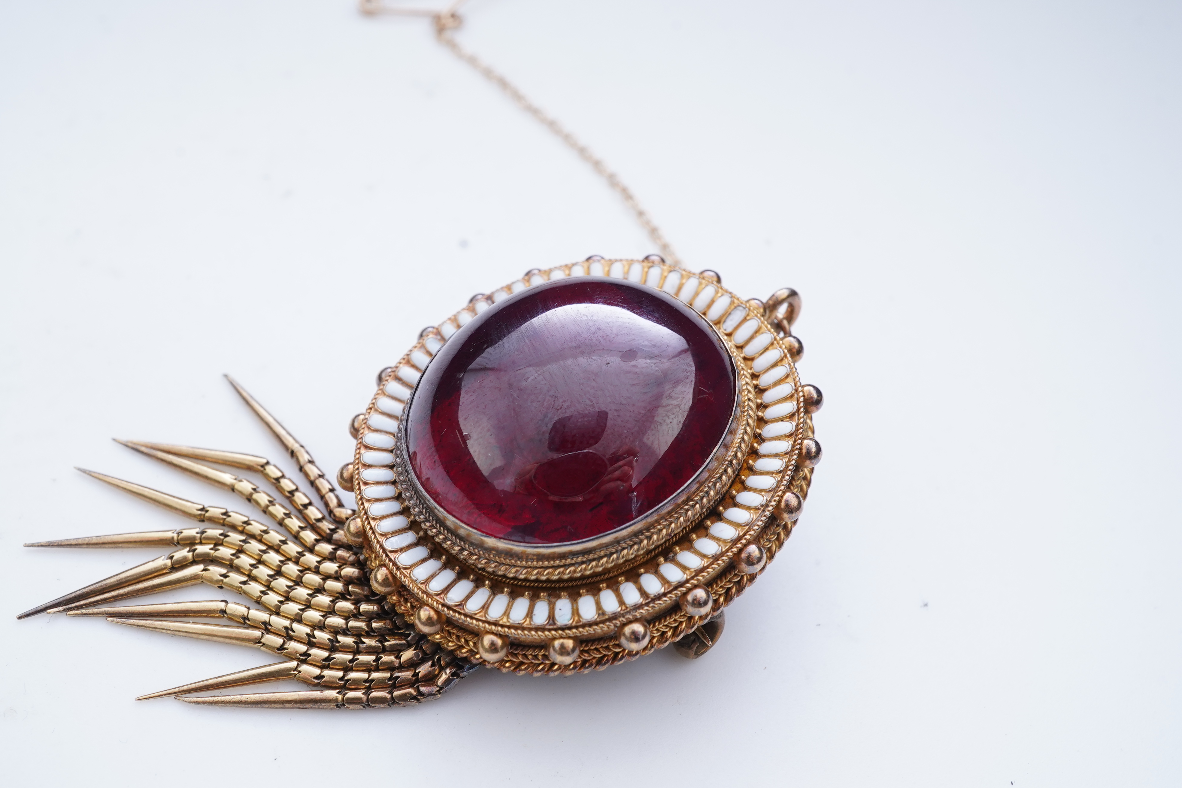 A Victorian garnet and enamel brooch, mid 19th century